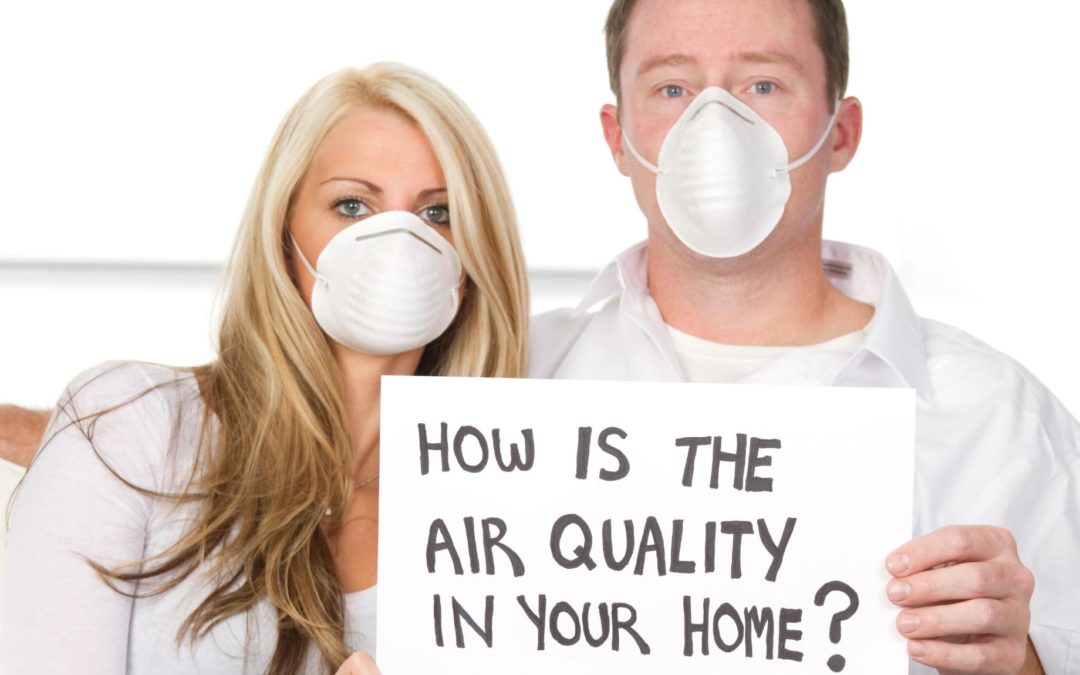 People holding a 'How is the air quality in your home?' placard