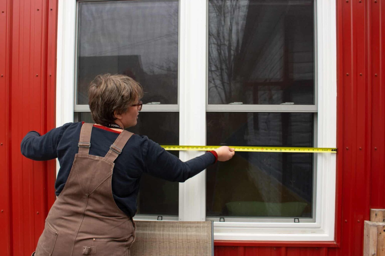 An Energy Advisor at work measuring window.