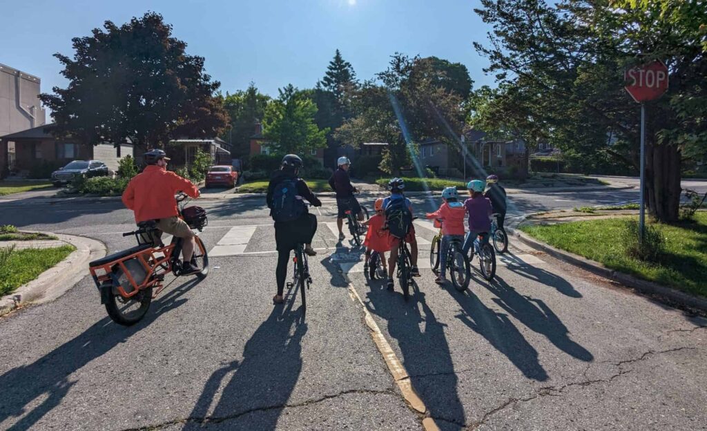 Jason Leaver and Marvin Macaraig lead their bike bus in Toronto, one Tuesday morning in June.