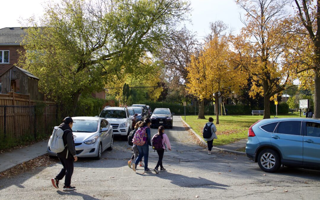 Students crossing a congested street on their way to school
