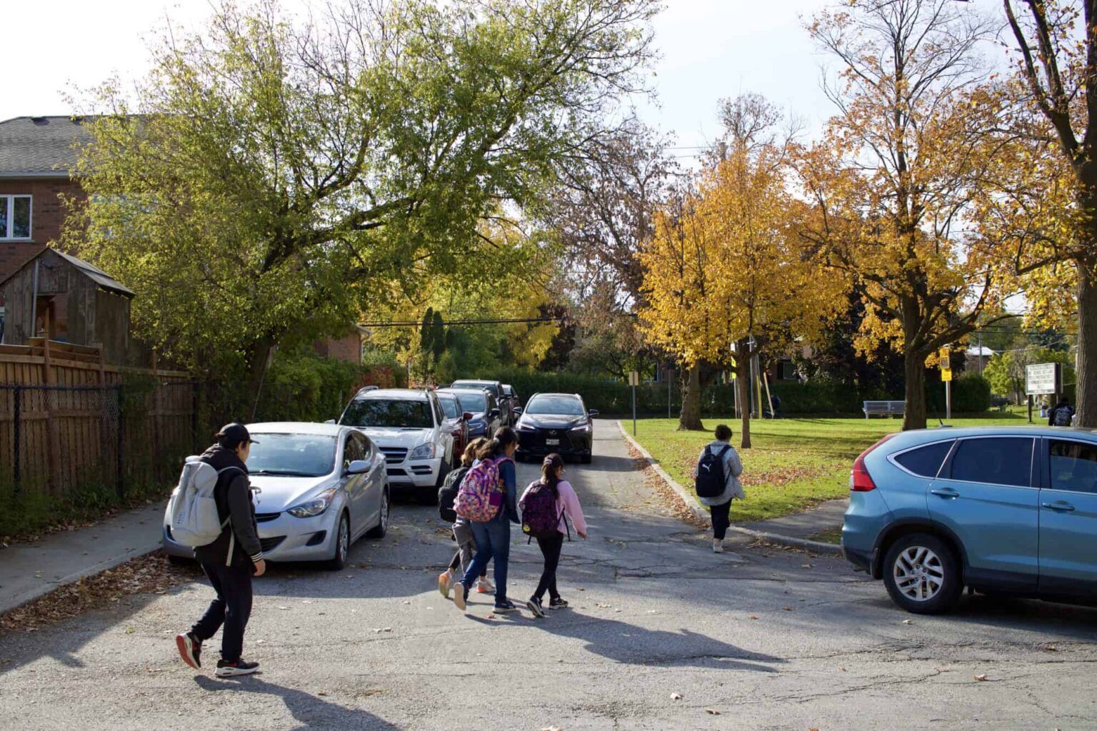 Students crossing a congested street on their way to school