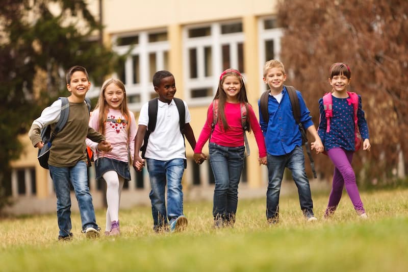 Kids walking through grass