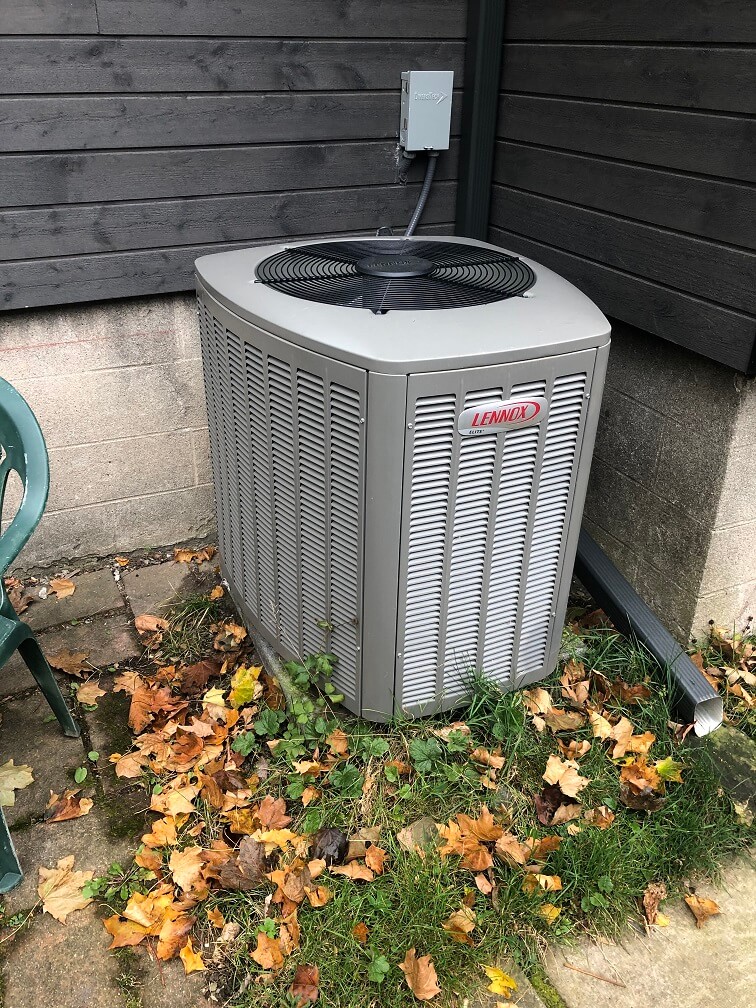 Heat pump outside against corner of house