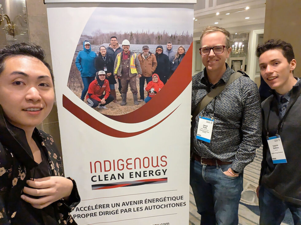 GCC Staff gathered around a banner for Indigenous Clean Energy