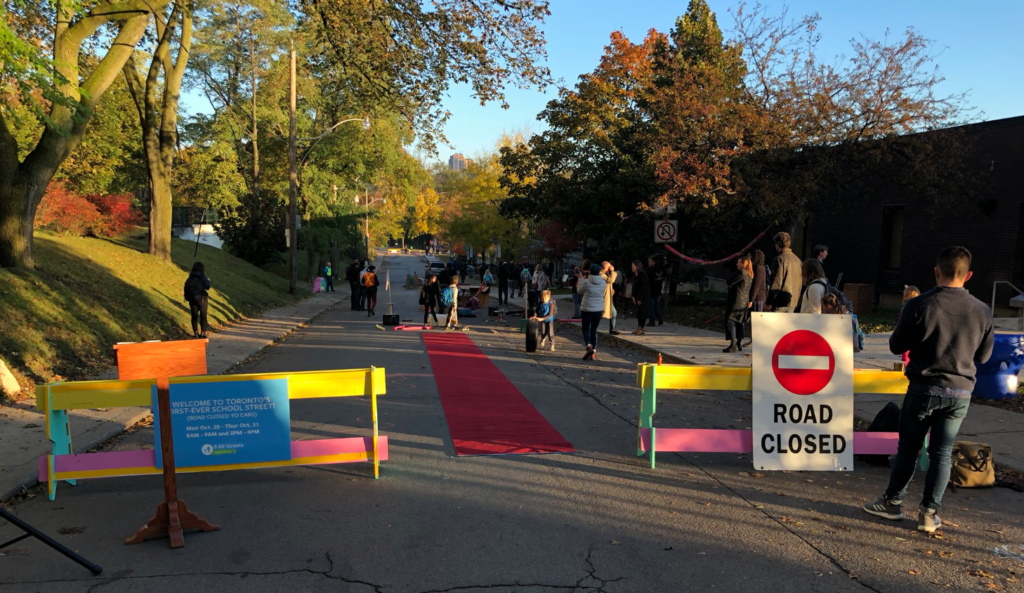 School Street with road closed to traffic, where children and families walk and cycle freely.