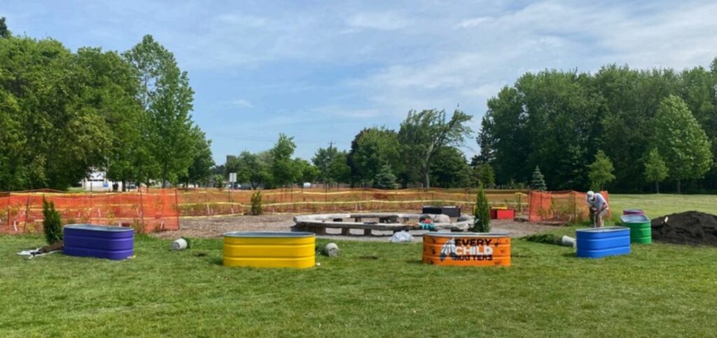 A newly created healing forest with colourful seating, planting beds, and native landscaping.